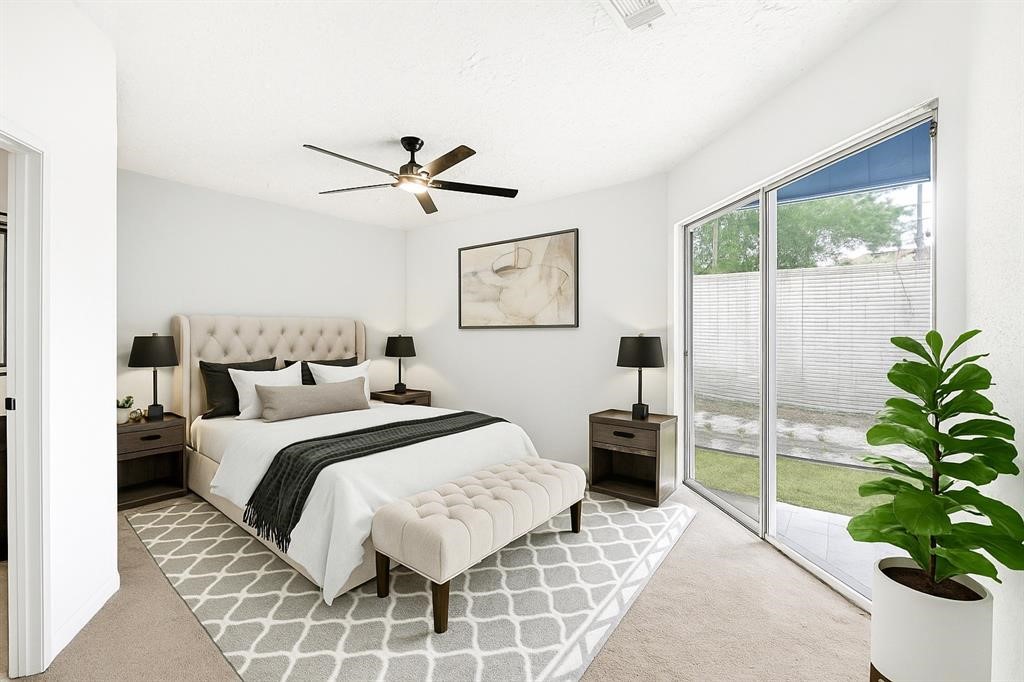 8302 Country Wind Lane Houston, TX 77040 - Photo 11 of 20 a bedroom with a balcony a bed and a potted plant