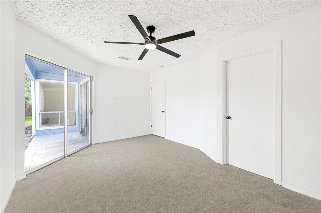 8302 Country Wind Lane Houston, TX 77040 - Photo 12 of 20 a view of a livingroom with a ceiling fan and window