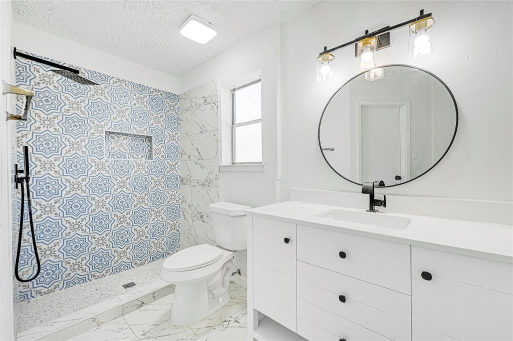8302 Country Wind Lane Houston, TX 77040 - Photo 13 of 20 a bathroom with a toilet a sink and mirror