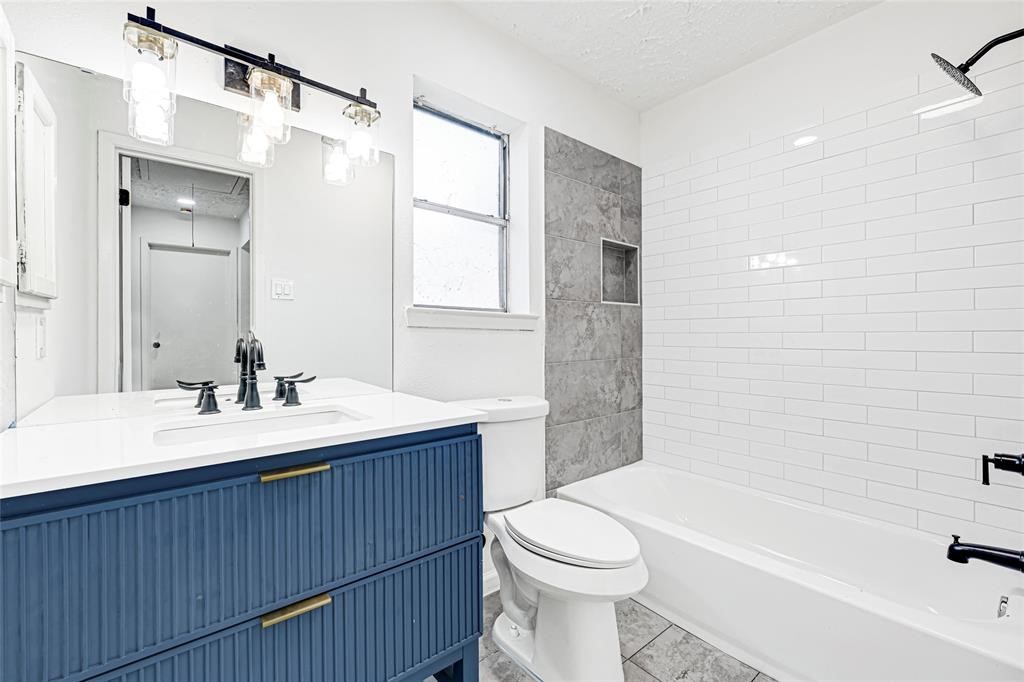 8302 Country Wind Lane Houston, TX 77040 - Photo 17 of 20 a bathroom with a sink a toilet and shower