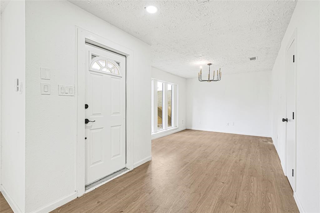 8302 Country Wind Lane Houston, TX 77040 - Photo 3 of 20 wooden floor in an empty room