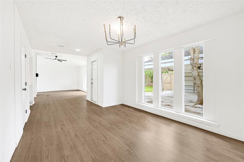 8302 Country Wind Lane Houston, TX 77040 - Photo 5 of 20 wooden floor in an empty room with a window