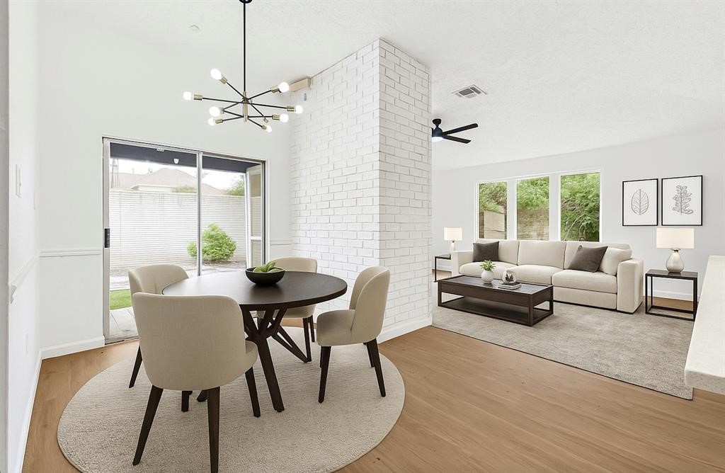 8302 Country Wind Lane Houston, TX 77040 - Photo 10 of 20 a living room with furniture a table and a large window