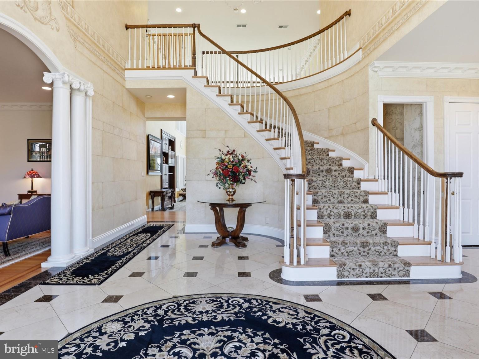 Elegant foyer with grand staircase.