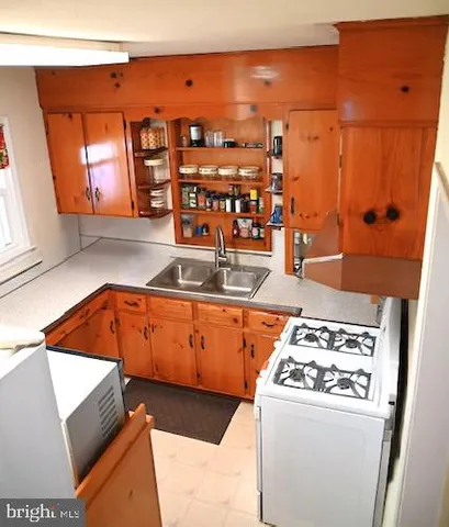 a kitchen with stainless steel appliances granite countertop a sink and a stove