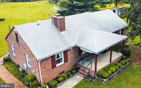 an aerial view of residential house with outdoor space and swimming pool