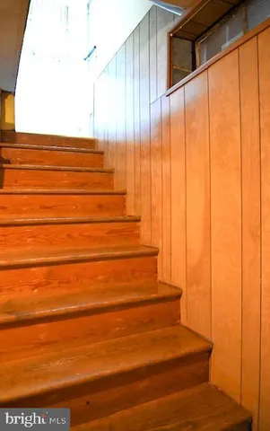 a view of a backyard with brick wall and a large window