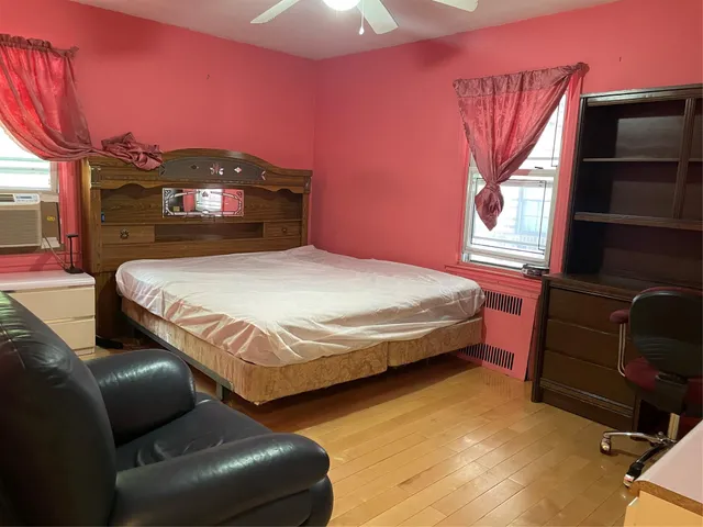 a bedroom with a bed and a television