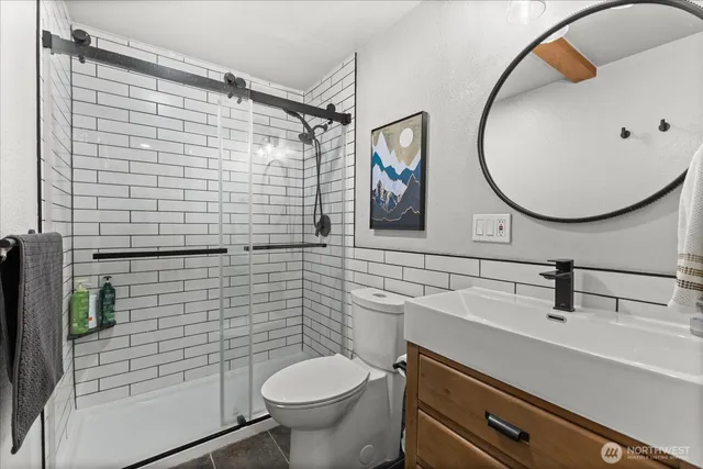 a bathroom with a sink toilet and shower