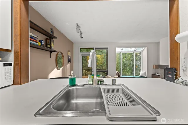 a kitchen with a sink and a large window
