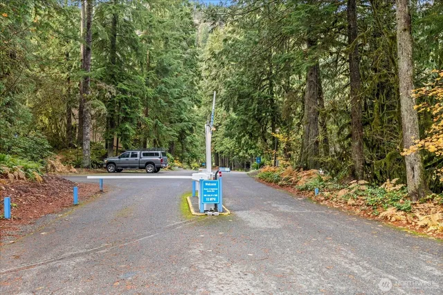 a view of a street with a car parked on the road