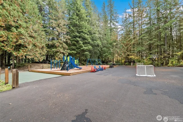 a sign board with yard and trees in the background