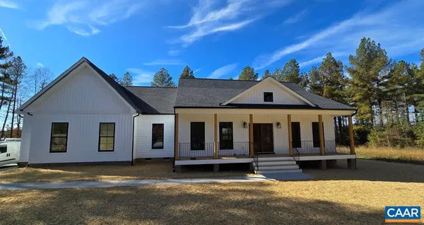 a view of a house with a yard and sitting area