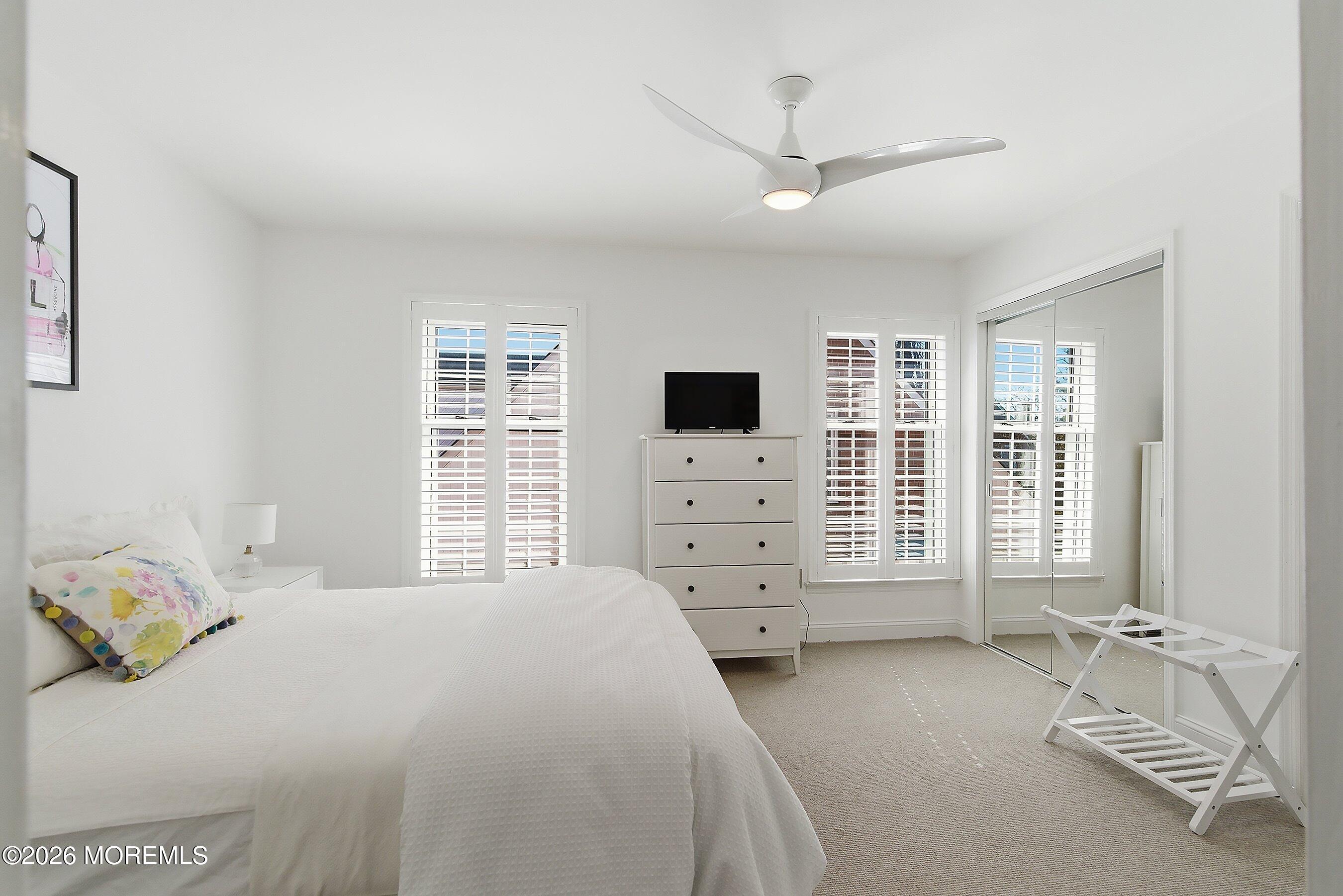 60 Wyckham Road Spring Lake Heights, NJ 07762 - Photo 20 of 26 a bedroom with a bed a dresser and a large window