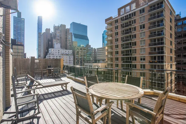 a view of a balcony with a table and chairs