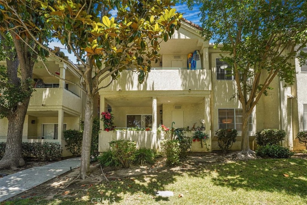 front view of a house with a tree in front of it