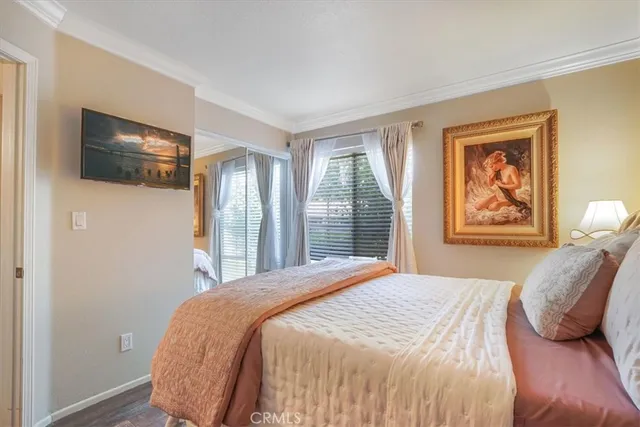 a bedroom with a large bed and a window