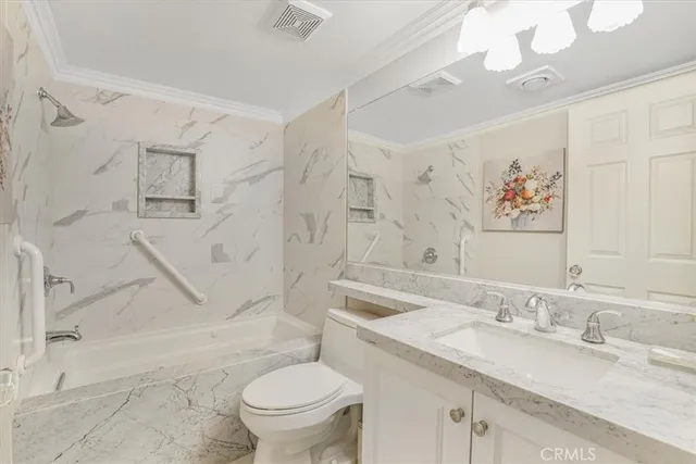 a bathroom with a granite countertop sink a toilet and a bathtub