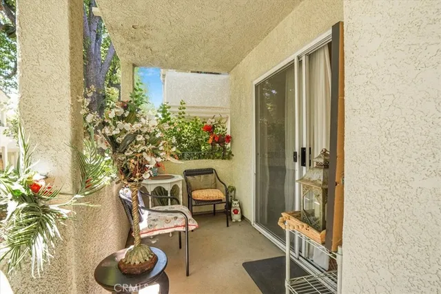 a balcony with furniture and flowers