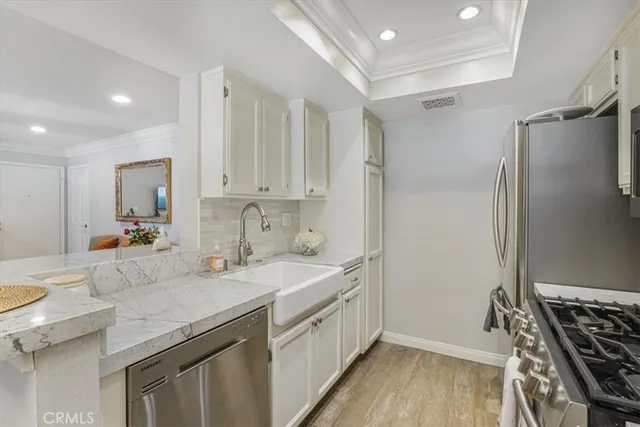 a kitchen with a sink stove and cabinets