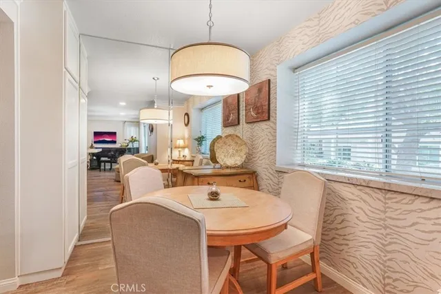 a living room with furniture a window and a chandelier