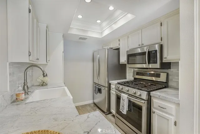 a kitchen with stainless steel appliances granite countertop a stove and a refrigerator