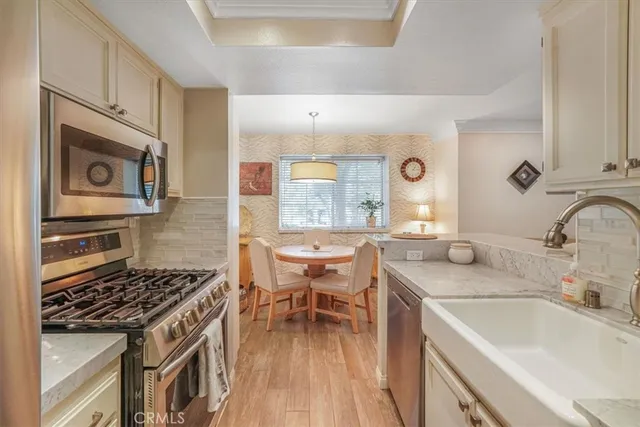 a kitchen with a sink stove and wooden cabinets