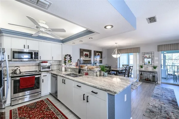a view of kitchen appliances and living room