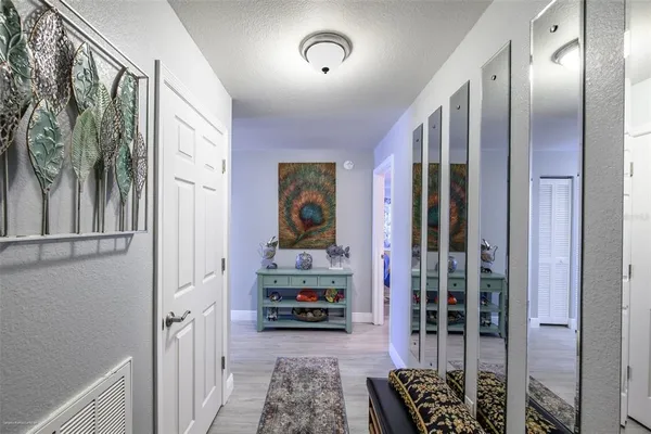 a view of hallway with livingroom and furniture