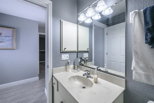 a bedroom with double bed and a chandelier