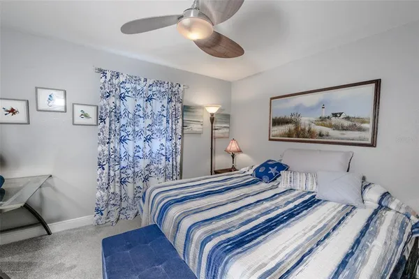 a spacious bedroom with a bed a couch and a window