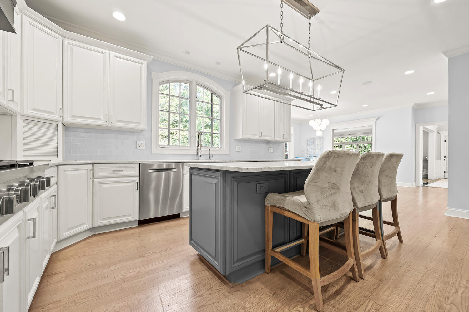 35 Logan Road New Canaan, CT 06840 - Photo 14 of 73 a kitchen with stainless steel appliances granite countertop a stove a sink dishwasher a dining table and chairs with wooden floor