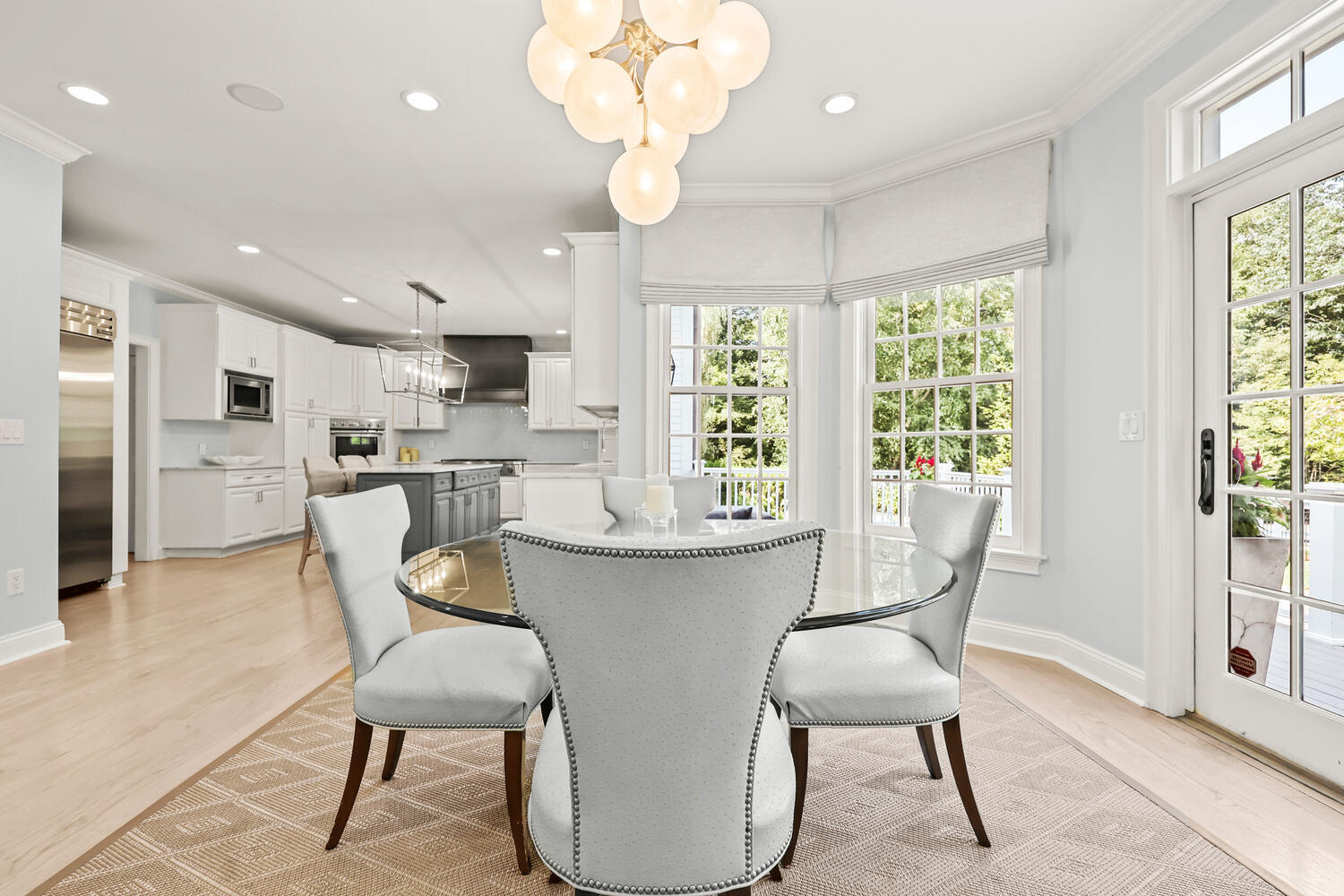 35 Logan Road New Canaan, CT 06840 - Photo 15 of 73 a dining room with stainless steel appliances furniture a large window and a kitchen view