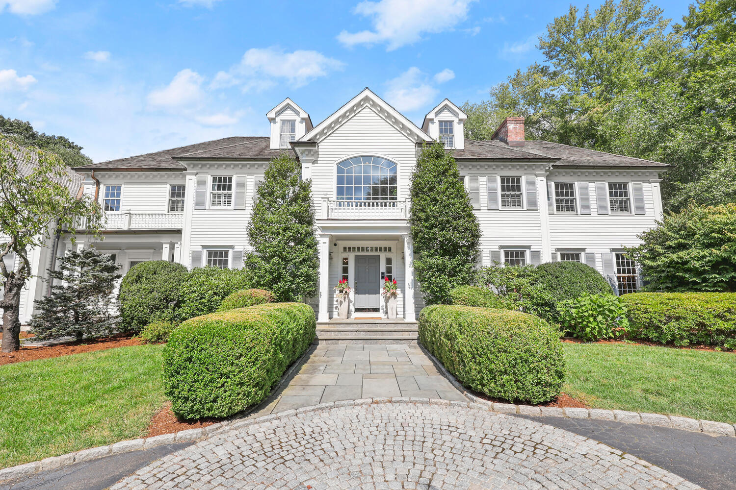 35 Logan Road New Canaan, CT 06840 - Photo 38 of 73 a front view of a house with a garden