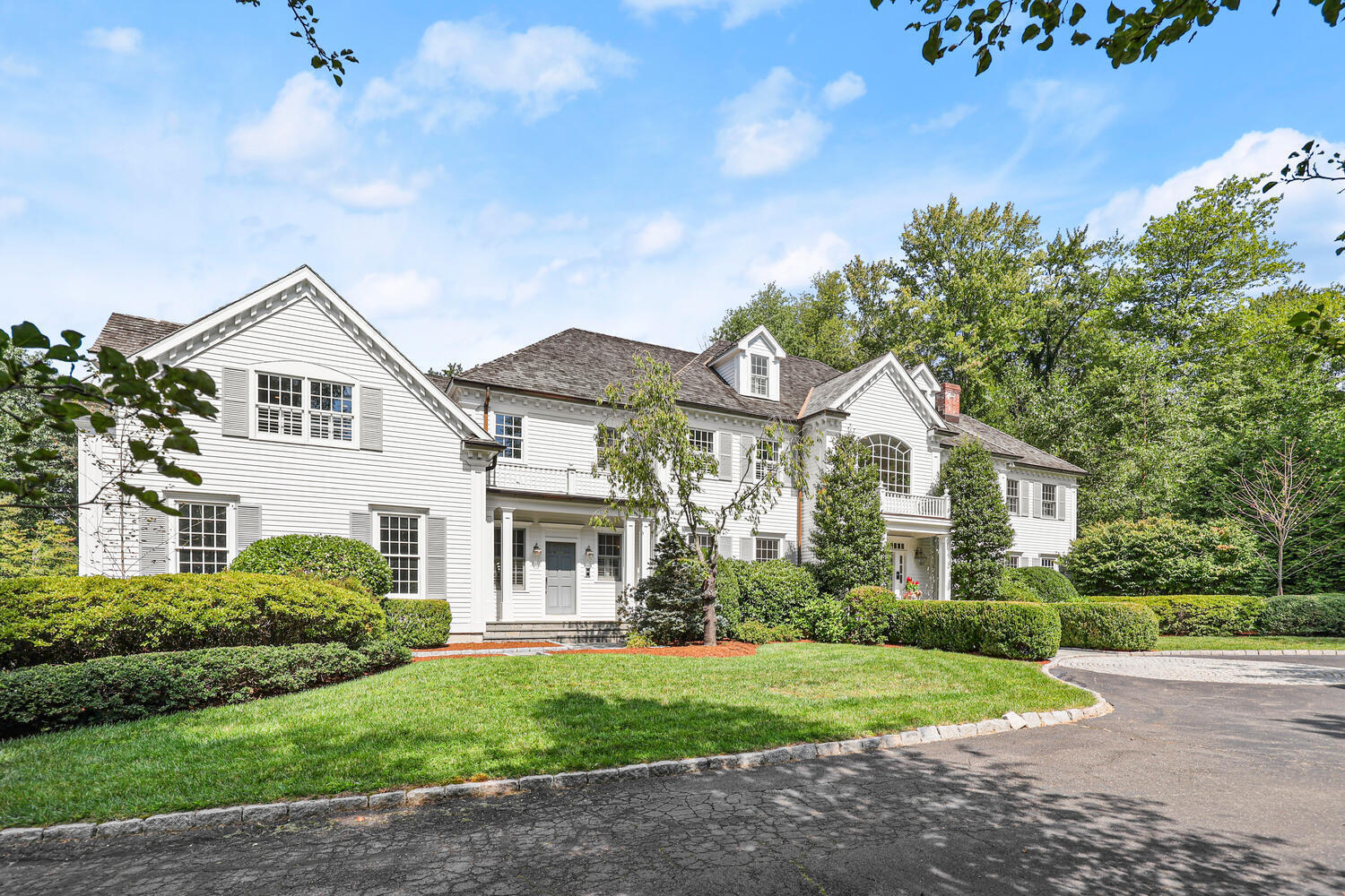 35 Logan Road New Canaan, CT 06840 - Photo 40 of 73 a front view of a house with a yard