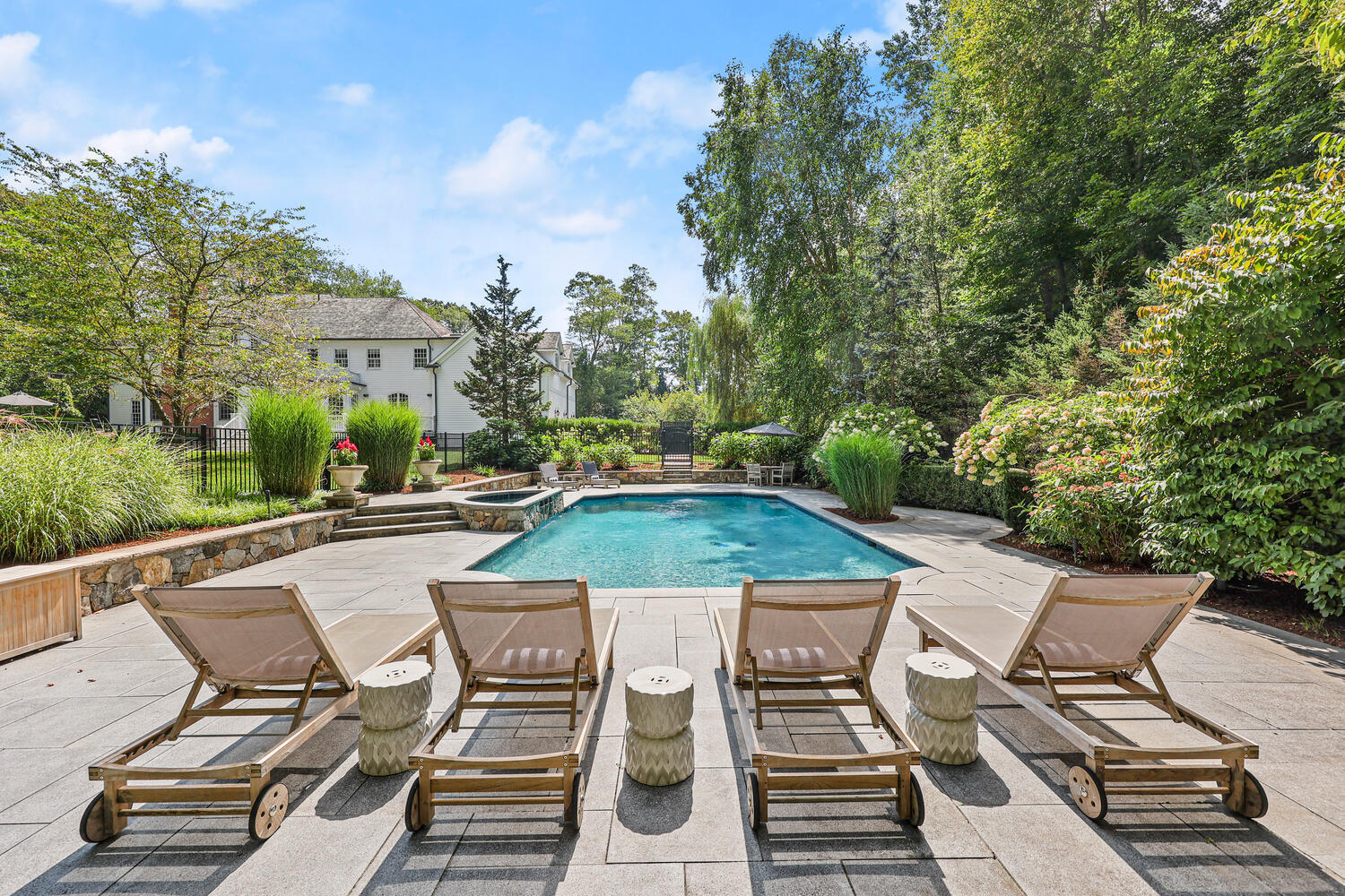 35 Logan Road New Canaan, CT 06840 - Photo 43 of 73 a view of a patio with table and chairs with wooden floor and fence