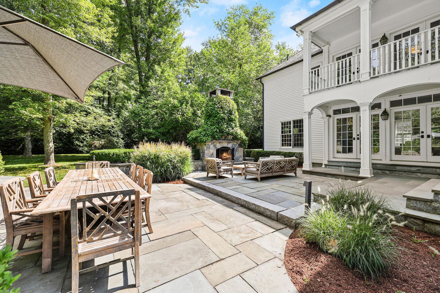 35 Logan Road New Canaan, CT 06840 - Photo 47 of 73 a view of a patio with couches table and chairs and potted plants