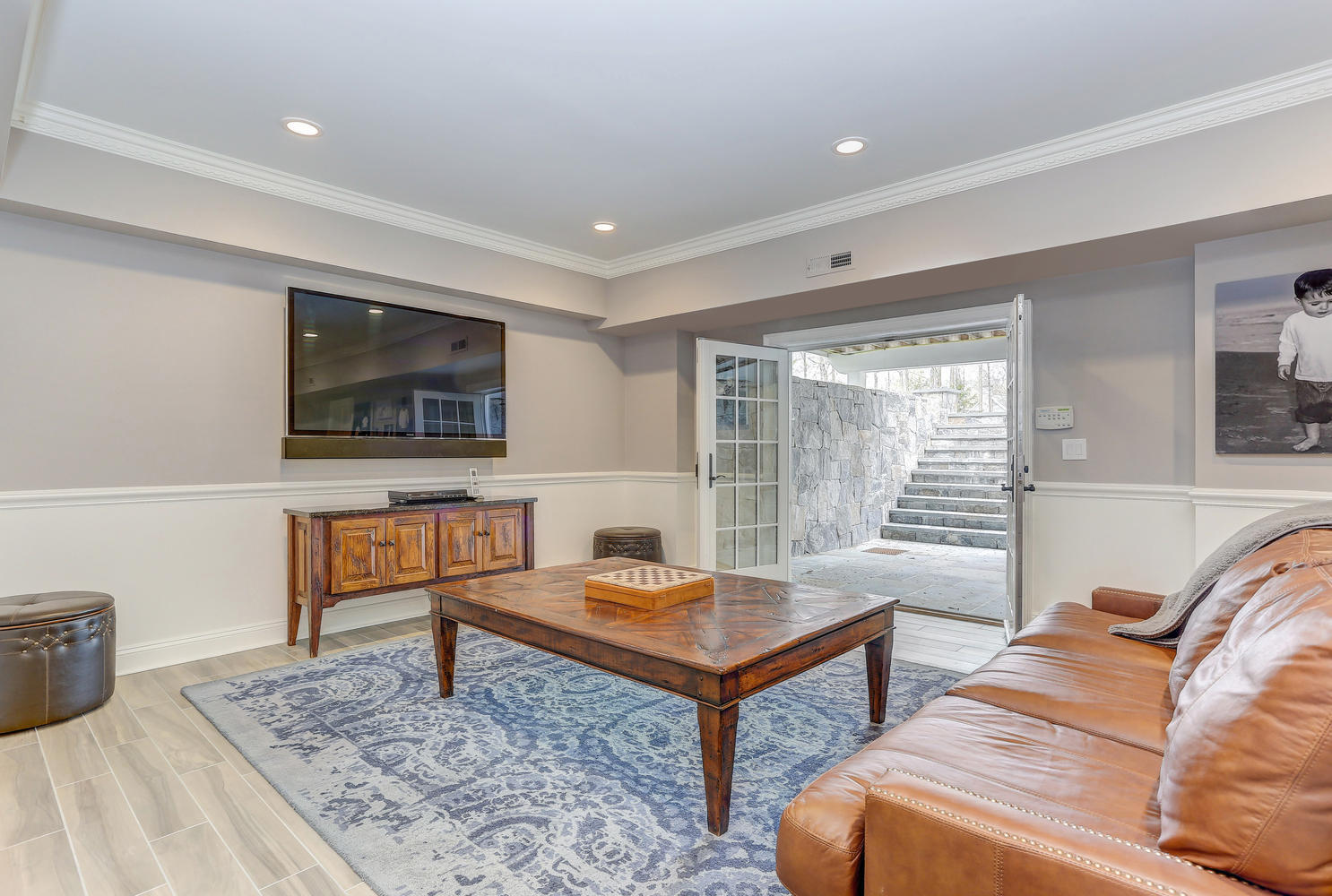 35 Logan Road New Canaan, CT 06840 - Photo 54 of 73 a living room with furniture and a flat screen tv
