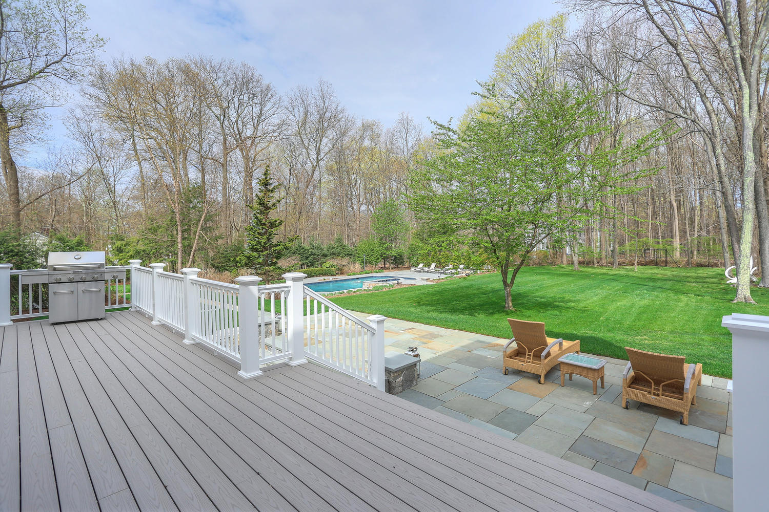 35 Logan Road New Canaan, CT 06840 - Photo 73 of 73 a view of a chair and tables on the wooden deck