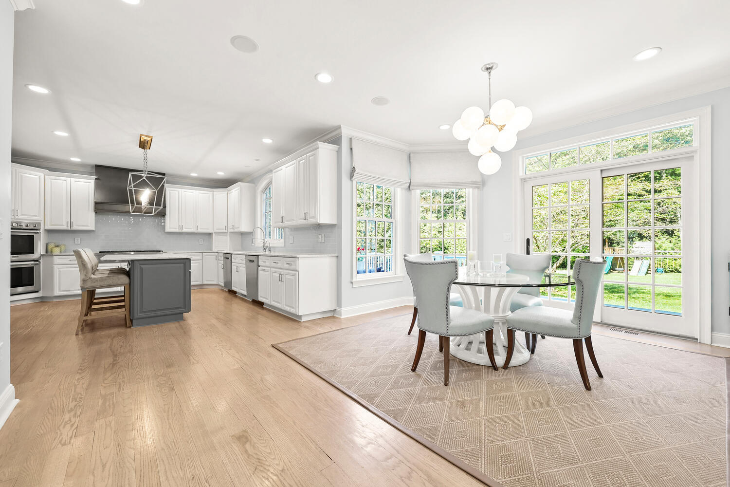 35 Logan Road New Canaan, CT 06840 - Photo 10 of 73 a dining room with wooden floor a chandelier a glass table and chairs