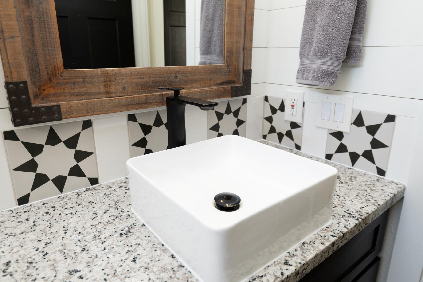 16990 Covina Road Bend, OR 97707 - Photo 15 of 56 a bathroom with a granite countertop sink and a mirror