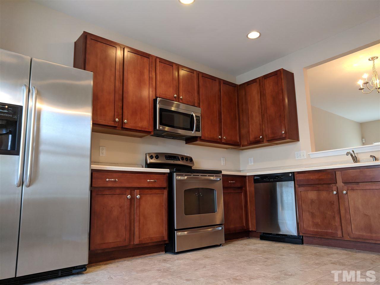 3124 Binghampton Lane Raleigh, NC 27604 - Photo 2 of 19 a kitchen with stainless steel appliances granite countertop a refrigerator a stove a sink and a microwave
