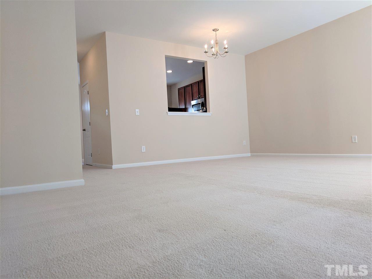 3124 Binghampton Lane Raleigh, NC 27604 - Photo 7 of 19 en empty room with windows and fireplace