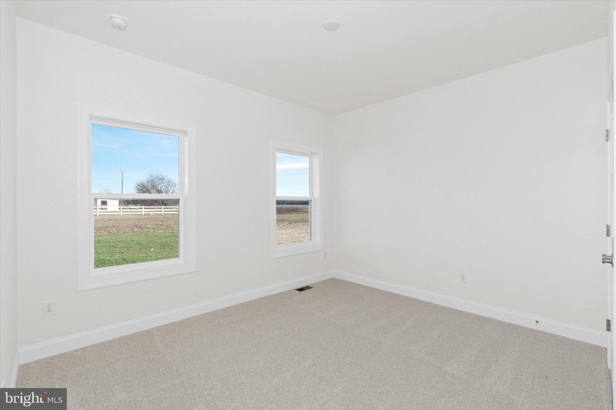 22484 Hummingbird Road, Unit 13 Ellendale, DE 19941 - Photo 22 of 34 an empty room with a window