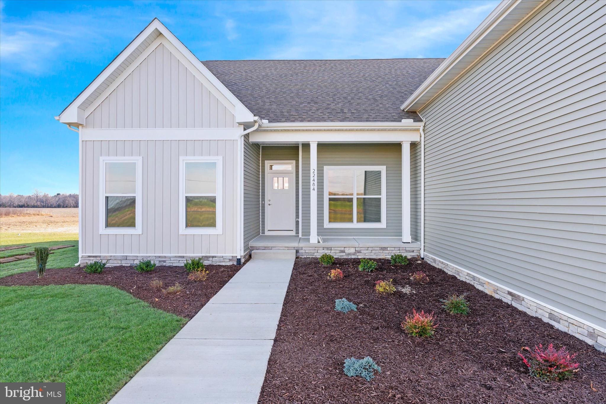 22484 Hummingbird Road, Unit 13 Ellendale, DE 19941 - Photo 32 of 34 a front view of a house with a yard