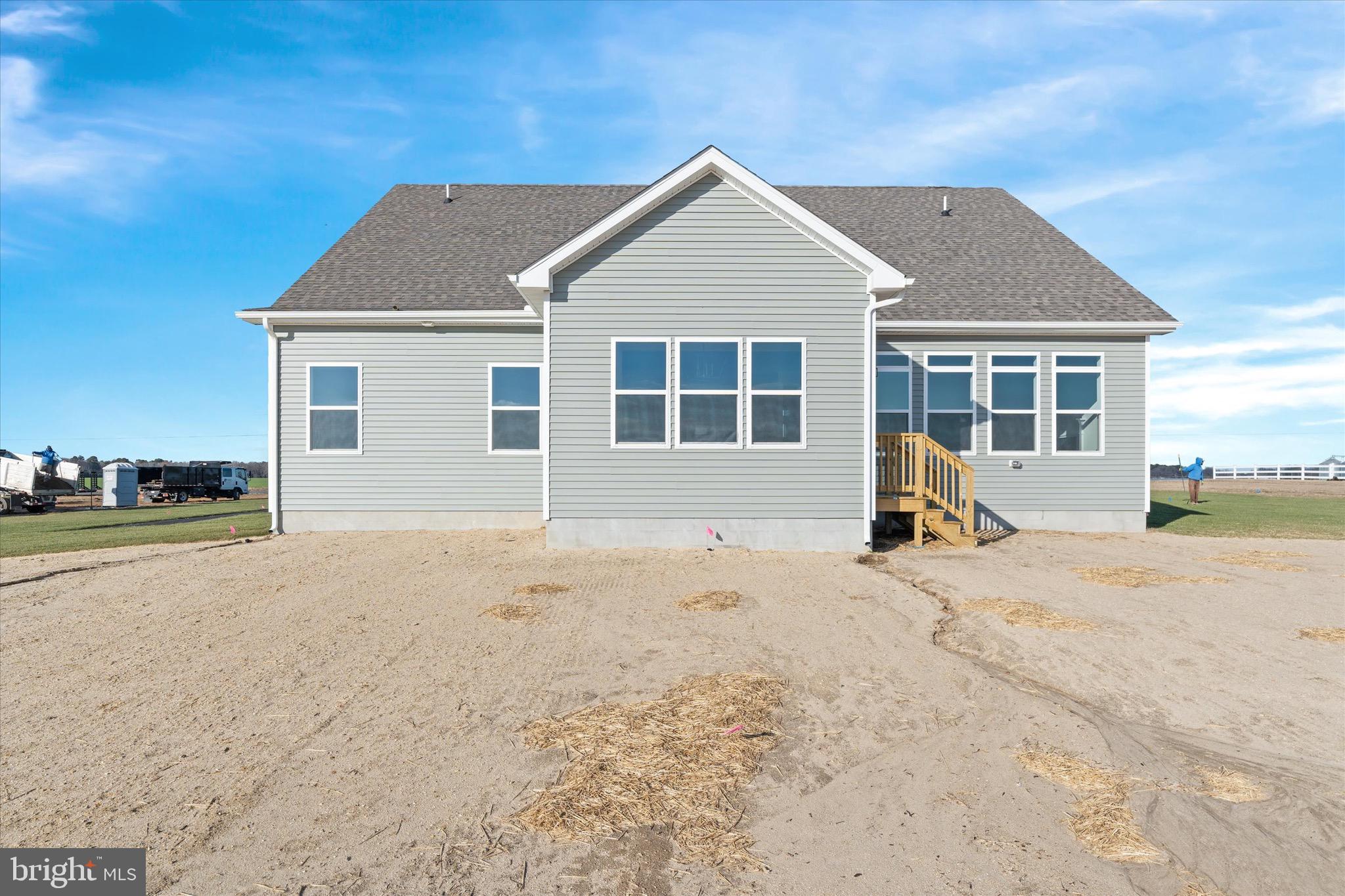 22484 Hummingbird Road, Unit 13 Ellendale, DE 19941 - Photo 34 of 34 a view of a house with a yard and road