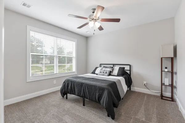 a bedroom with a bed and window