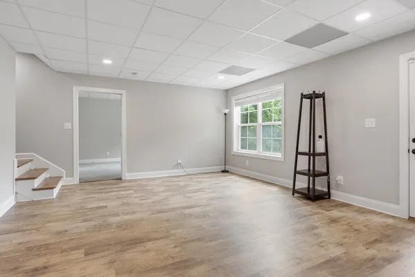 an empty room with windows and closet