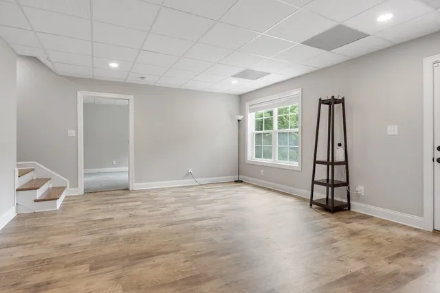 an empty room with windows and closet