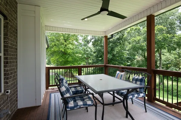 a view of a balcony with table and chairs